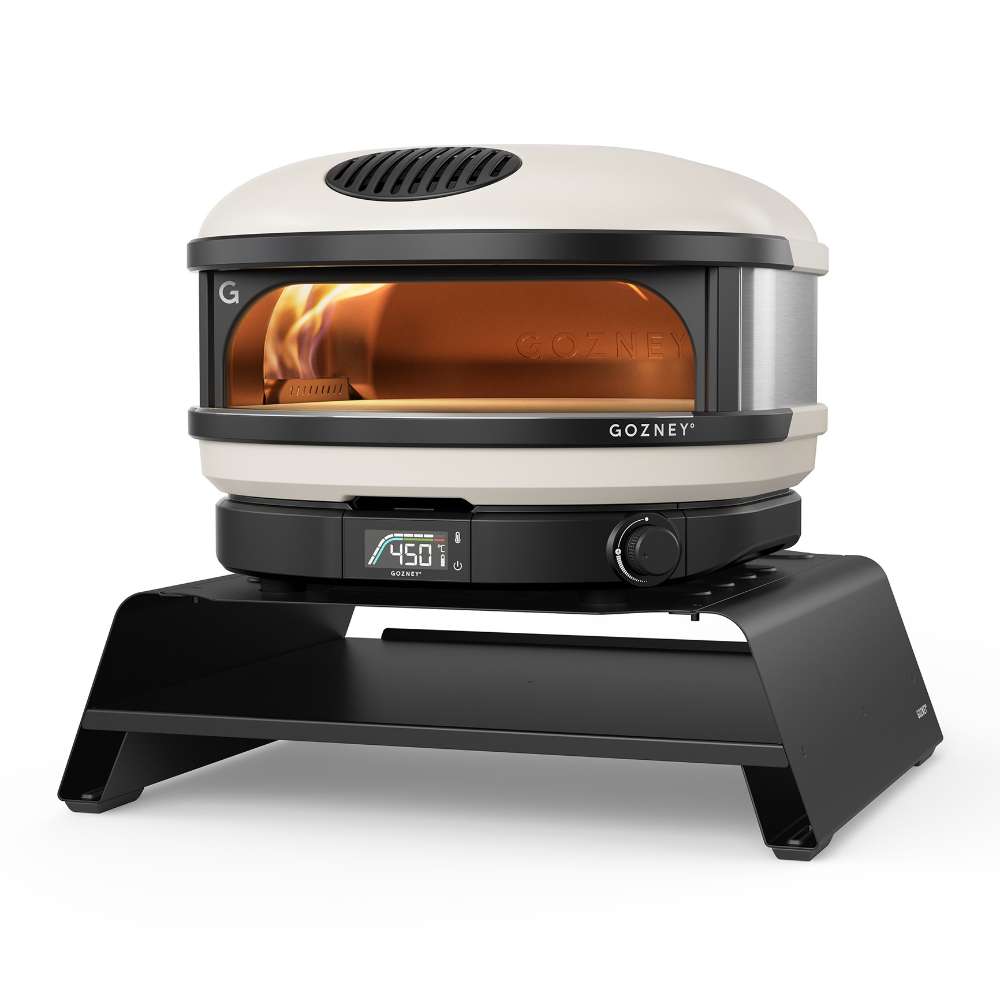 Gozney Arc Pizza Oven Booster on white with a Bone Arc oven standing on it at an angle and the display reading 450.