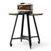 Gozney Arc Pizza Oven Stand angled view on white with a Bone Arc pizza oven on top two wooden side shelves a lower shelf and four casters.