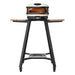 Gozney Arc Pizza Oven Stand straight-on front view on white with a Bone Arc pizza oven on top the wooden side shelves extended and casters on the black legs.