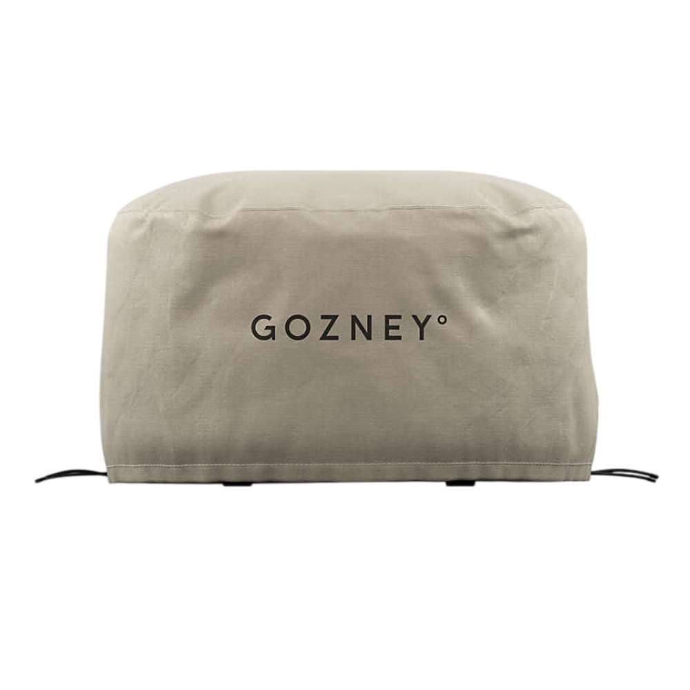 Gozney Arc Pizza Oven XL Cover on white from the front showing the stone-colored canvas cover with the Gozney wordmark and the drawcord at the hem.