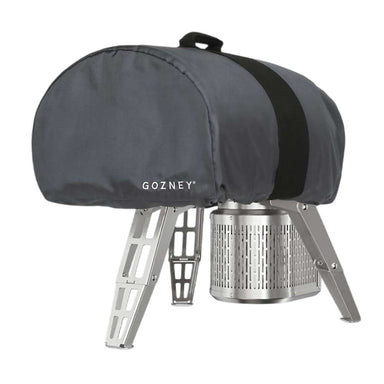 Gozney Roccbox Cover on white fitted over a Roccbox with the legs extended showing the dark gray shell the carry handle and the Gozney wordmark.