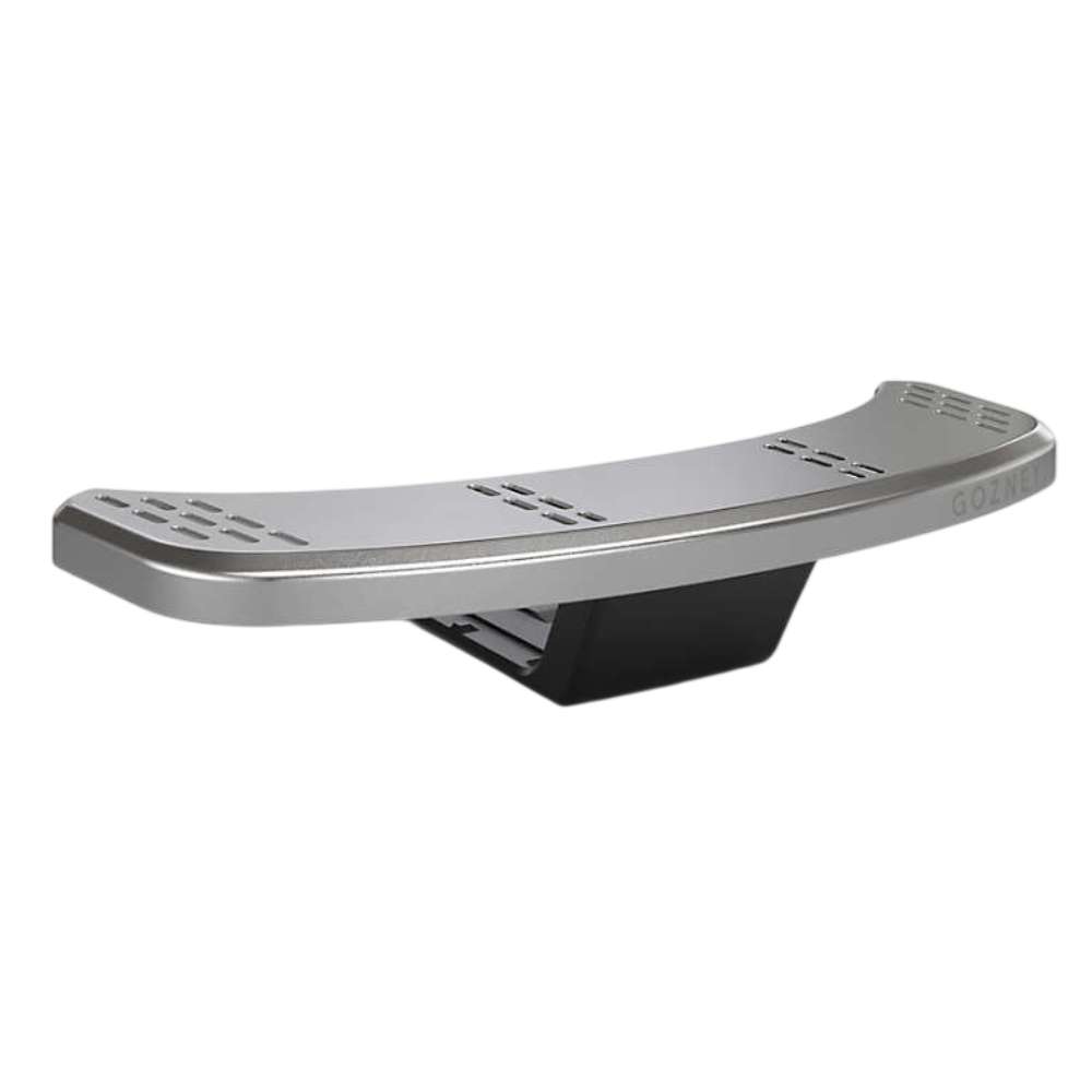 Gozney Tread Mantel on white seen from the front showing the curved stainless ledge with its slotted pattern and the black bracket beneath.