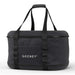 Gozney Tread Travel Bag angled on white showing the zippered black shell and the twin webbing handles.