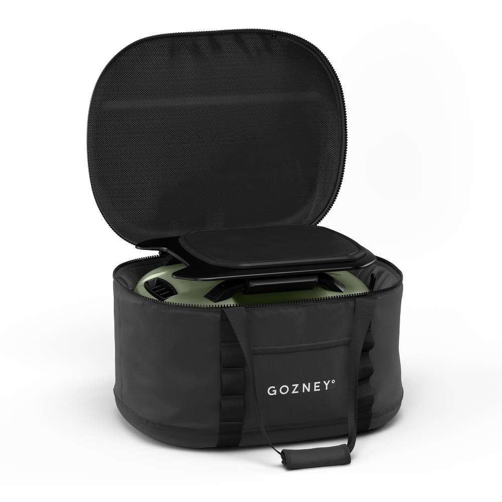 Gozney Tread Travel Bag open on white with the lid flipped back showing an Olive Tread oven packed inside.