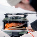 Gozney Venture Turning Peel turning a pizza inside an Olive Tread oven in the snow with steam pouring out of the mouth.