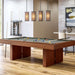 Grey Crate & Barrel Walnut Pool Table with Wall Rack and Accessories at an angle in a game room under four pendant lights with coloured balls on the grey felt and a wall cue rack behind
