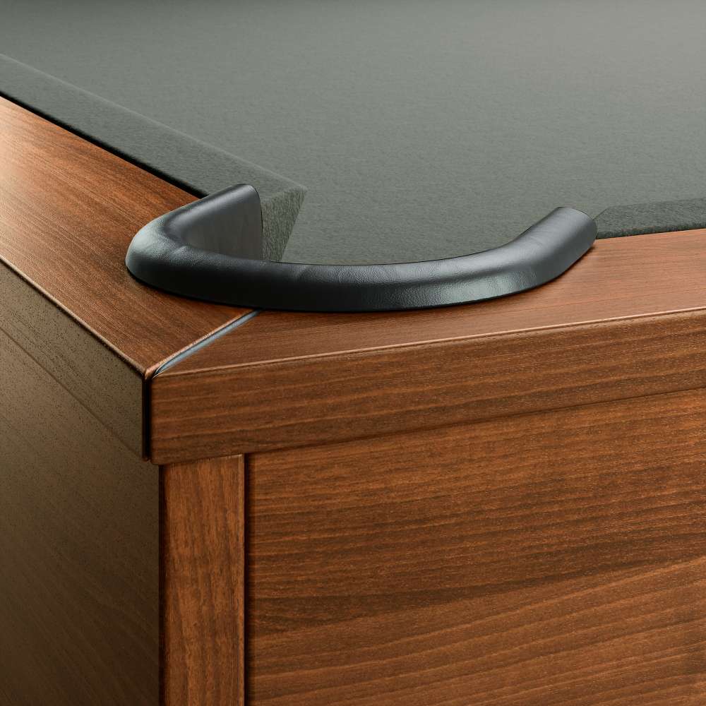 Grey Crate & Barrel Walnut Pool Table with Wall Rack and Accessories in close up on a corner pocket showing the black leather drop pocket, grey felt and the walnut rail