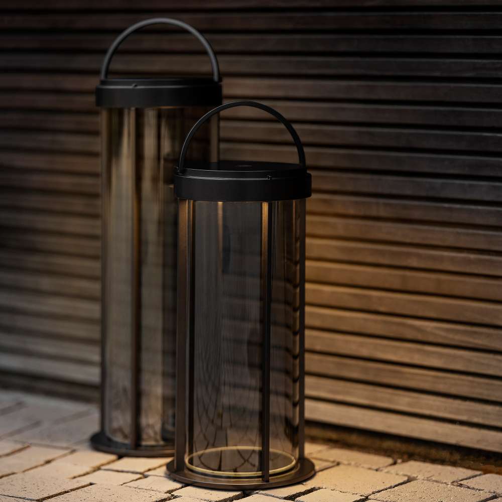 Gunmetal Crate & Barrel Blomus Mituro Rechargeable LED Indoor/Outdoor Lantern shown in a styled setting, a dimmable rechargeable lamp for tabletops indoors and out