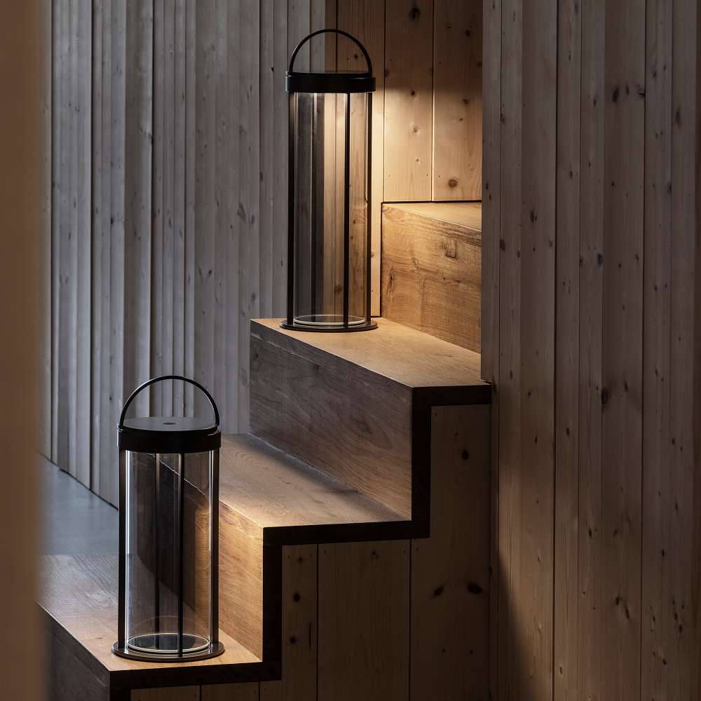 Gunmetal Crate & Barrel Blomus Mituro Rechargeable LED Indoor/Outdoor Lantern shown in a styled setting, a slim gunmetal aluminum frame with an integrated carry handle