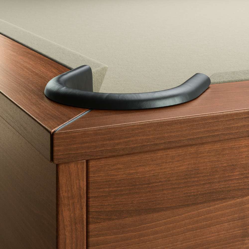 Khaki Crate & Barrel Walnut Pool Table with Wall Rack and Accessories in close up on a corner pocket showing the black leather drop pocket, khaki felt and the walnut rail