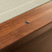 Khaki Crate & Barrel Walnut Pool Table with Wall Rack and Accessories in close up on the walnut rail with a small metal sight dot beside the khaki felt