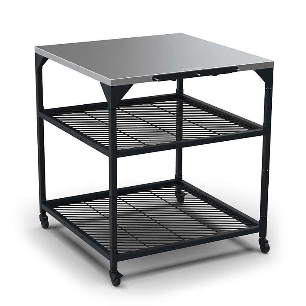 Large Ooni Modular Table angled view from above showing the stainless top, both mesh shelves and the casters on the legs.