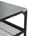 Large Ooni Modular Table close view of one corner of the stainless top with the ooni logo embossed and the mesh shelf below.