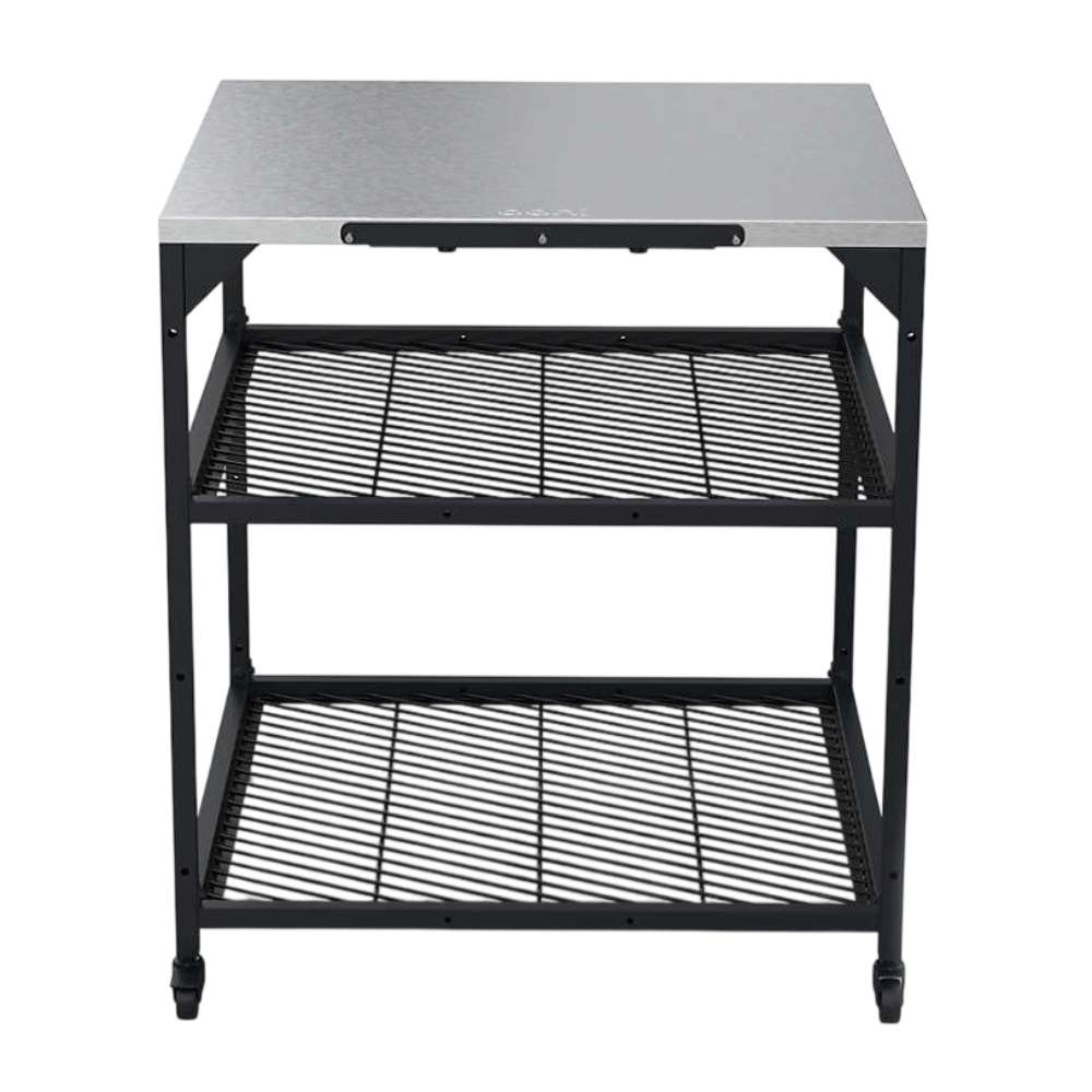 Large Ooni Modular Table front view of the wide stainless top with two black mesh shelves and four black legs.