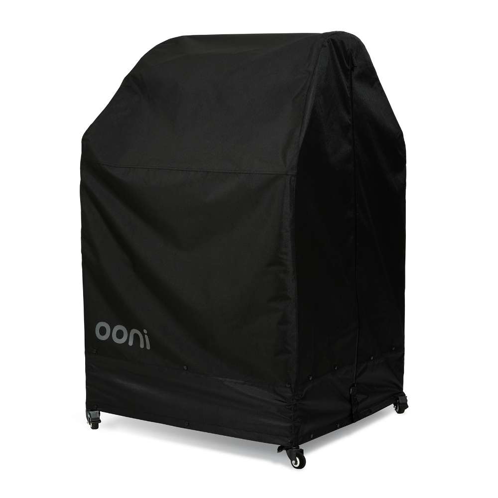 Large Ooni Table and Pizza Oven Cover angled view of the black cover with the ooni logo over a wide table on casters.