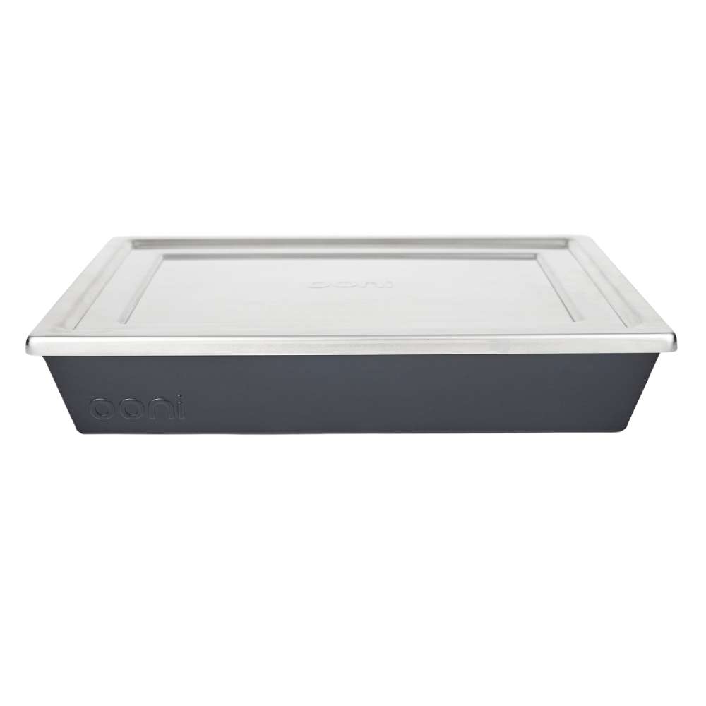 Medium Ooni Detroit Pizza Pan front view on white with the stainless steel lid in place and the ooni logo embossed on the dark gray pan.