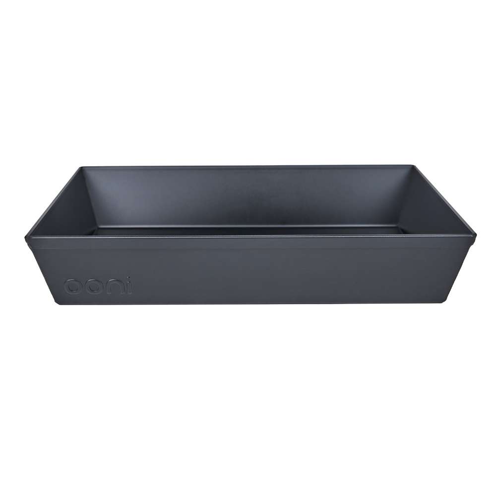 Medium Ooni Detroit Pizza Pan shown empty without its lid, angled to show the sloped dark gray walls and the ooni logo embossed on the front.