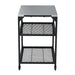Medium Ooni Modular Table with a stainless top, two black mesh shelves and casters on the feet.