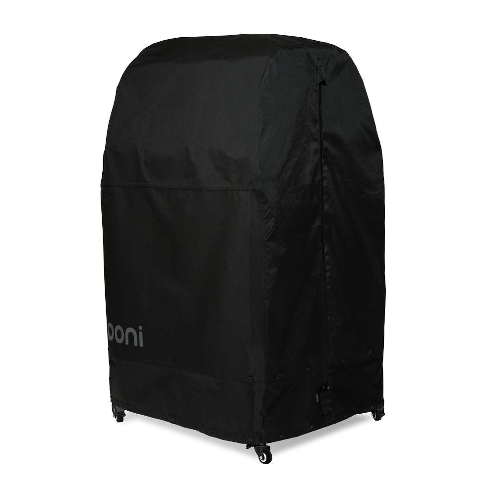 Medium Ooni Table and Pizza Oven Cover angled view of the rounded black cover with the ooni logo over a table on casters.