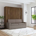 Modern Walnut Inovabed Wall Bed with Sofa and Two Nightstands closed as a gray sofa in a loft-style room with a wall sconce and a tall window