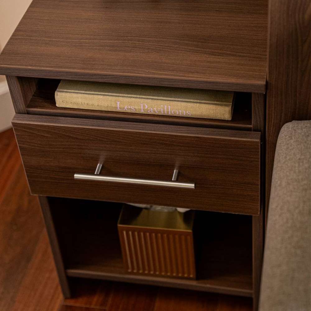 Modern Walnut Inovabed Wall Bed with Sofa and Two Nightstands in close-up on one nightstand with a book in the open cubby and a gold box on the lower shelf