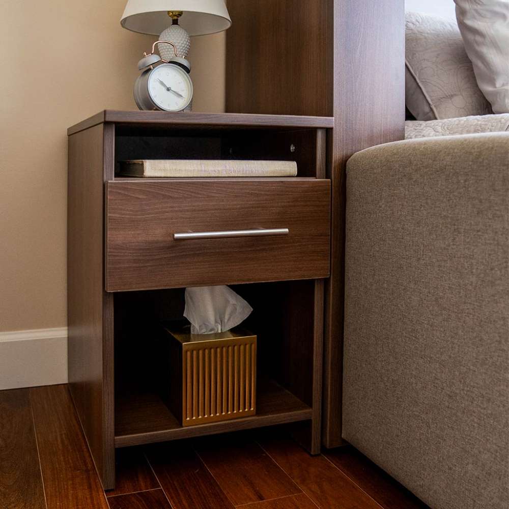 Modern Walnut Inovabed Wall Bed with Sofa and Two Nightstands showing one nightstand beside the bed with a table lamp, an alarm clock, a book in the cubby and a tissue box on the lower shelf
