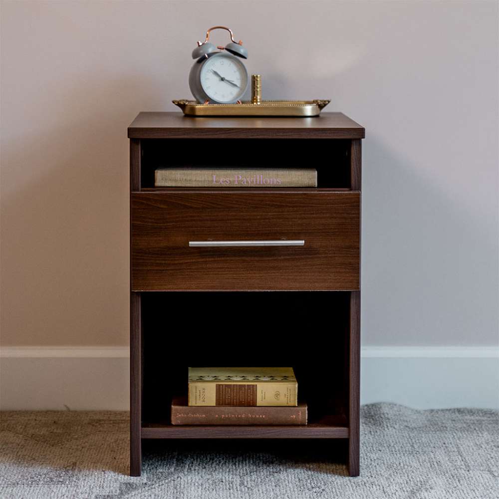 Modern Walnut Inovabed Wall Bed with Sofa and Two Nightstands showing one nightstand topped with an alarm clock on a brass tray, books in the cubby and more books on the lower shelf