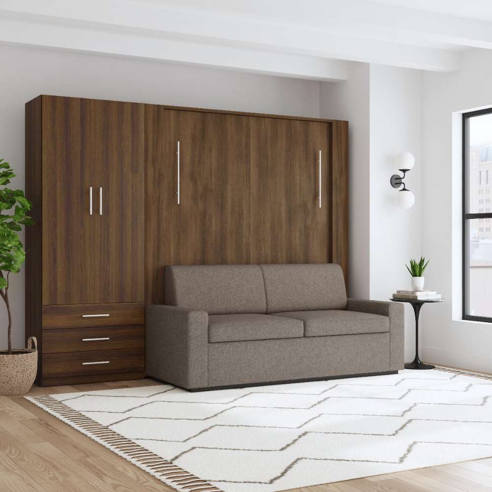 Modern Walnut Inovabed Wall Bed with Sofa and Wide Flex Cabinet closed as a gray sofa in a bright room beside the Wide Flex Cabinet, with a round side table alongside