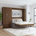 Modern Walnut Inovabed Wall Bed with Sofa and Wide Flex Cabinet opened in a bright room beside the Wide Flex Cabinet, with white bedding, a gray sofa base and two framed prints above the headboard