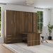 Modern Walnut Inovabed Wall Bed with Table and Two Narrow Flex Cabinets closed in a bright room with the table extended, a white office chair and both cabinet doors shut