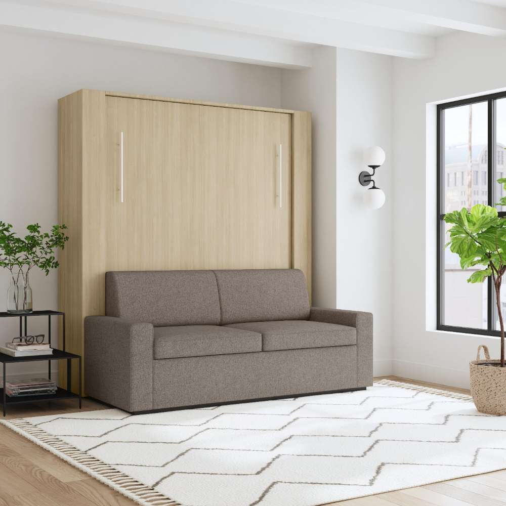 Natural Oak Inovabed Wall Bed with Sofa and Two Nightstands closed as a gray sofa in a loft-style room with a wall sconce and a tall window