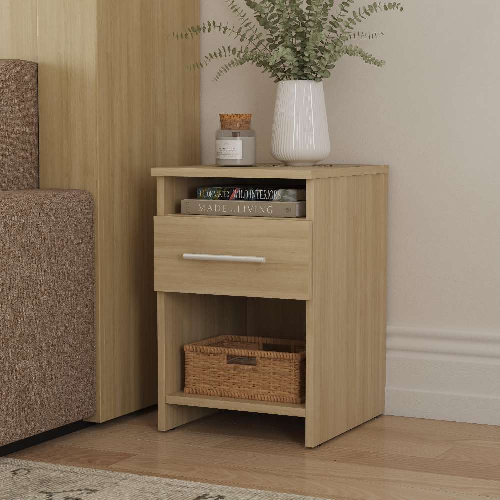Natural Oak Inovabed Wall Bed with Sofa and Two Nightstands showing one nightstand beside the sofa, styled with a vase of greenery, a candle, books in the open cubby and a woven basket below