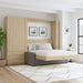 Natural Oak Inovabed Wall Bed with Sofa and Wide Flex Cabinet opened in a bright room beside the Wide Flex Cabinet, with white bedding, a gray sofa base and two framed prints above the headboard