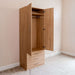 Natural Oak Inovabed Wall Bed with Sofa and Wide Flex Cabinet showing the Wide Flex Cabinet open at an angle in a room, with an empty wardrobe rod and three drawers below