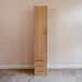 Natural Oak Inovabed Wall Bed with Table and Two Narrow Flex Cabinets showing one Narrow Flex Cabinet closed against a wall, with a tall door above three drawers