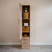 Natural Oak Inovabed Wall Bed with Table and Two Narrow Flex Cabinets showing one Narrow Flex Cabinet open and styled with woven baskets, folded towels, a hat and a small plant
