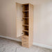 Natural Oak Inovabed Wall Bed with Table and Two Narrow Flex Cabinets showing one Narrow Flex Cabinet with its door open on empty shelves above three closed drawers