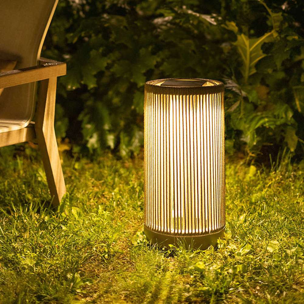 Natural Rope Crate & Barrel Alto Rope Outdoor Solar LED Lantern 17" shown in a styled outdoor setting, a rope-wrapped lantern on a teak base
