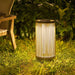 Natural Rope Crate & Barrel Alto Rope Outdoor Solar LED Lantern 17" shown in a styled outdoor setting, a rope-wrapped lantern on a teak base