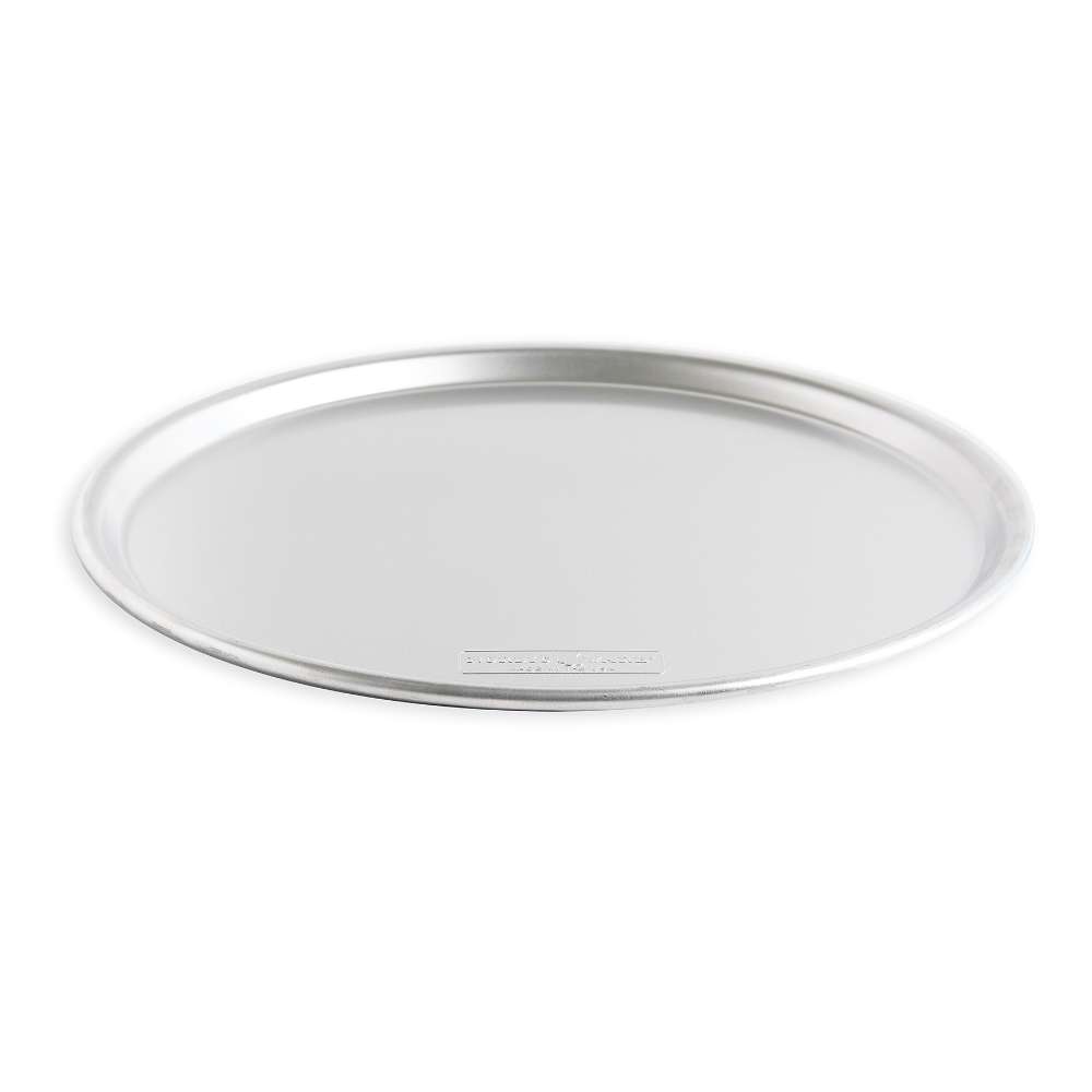 Nordic Ware Naturals 14" Traditional Pizza Pan at a low angle on white showing the shallow profile and the rolled rim.