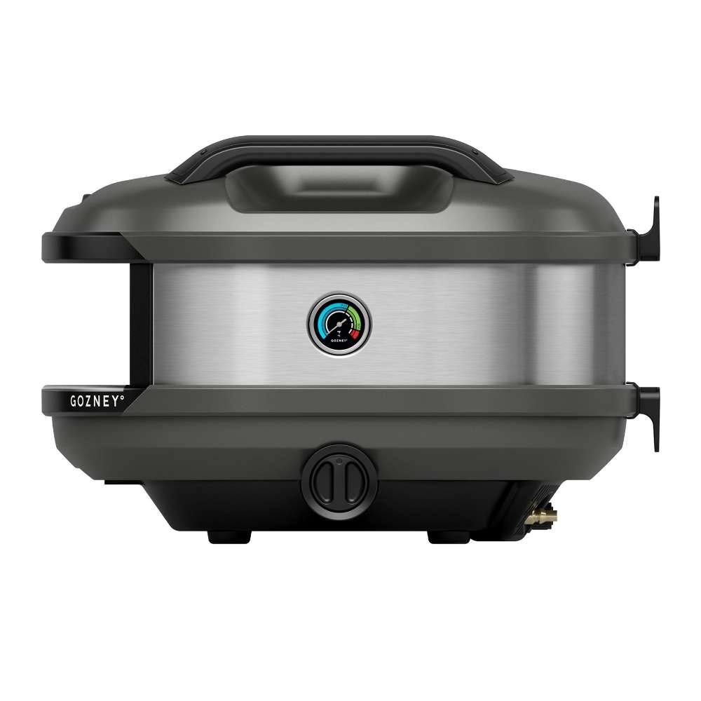 Off-Black Gozney Tread Pizza Oven side profile on white showing the brushed stainless side panel with its round temperature gauge and the gas fitting below.
