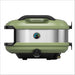 Olive Gozney Tread Pizza Oven side profile on white showing the green shell and the brushed stainless side panel with its round temperature gauge.