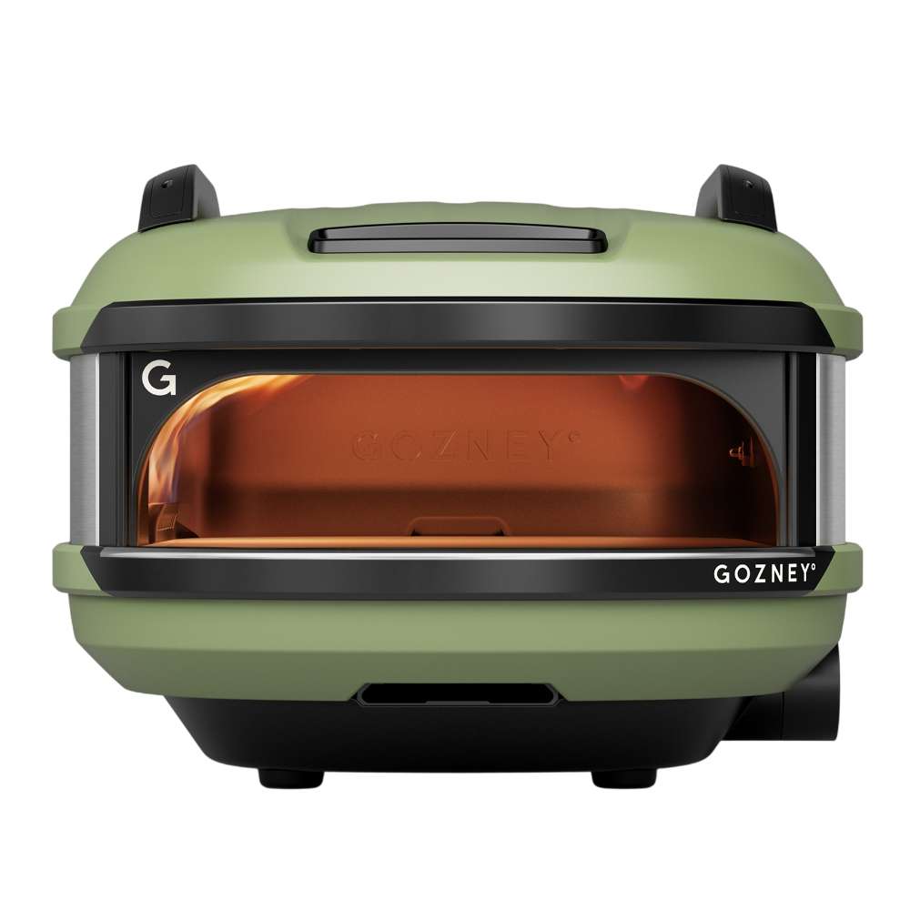 Olive Gozney Tread Pizza Oven straight-on front view on white with the wide arched mouth the copper-toned dome and the black carry handles on top.