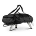 Ooni Koda 2 Carry Cover fitted over an oven seen from the rear right in all black with the ooni logo, carry straps over the top and the gas hose looped out below.