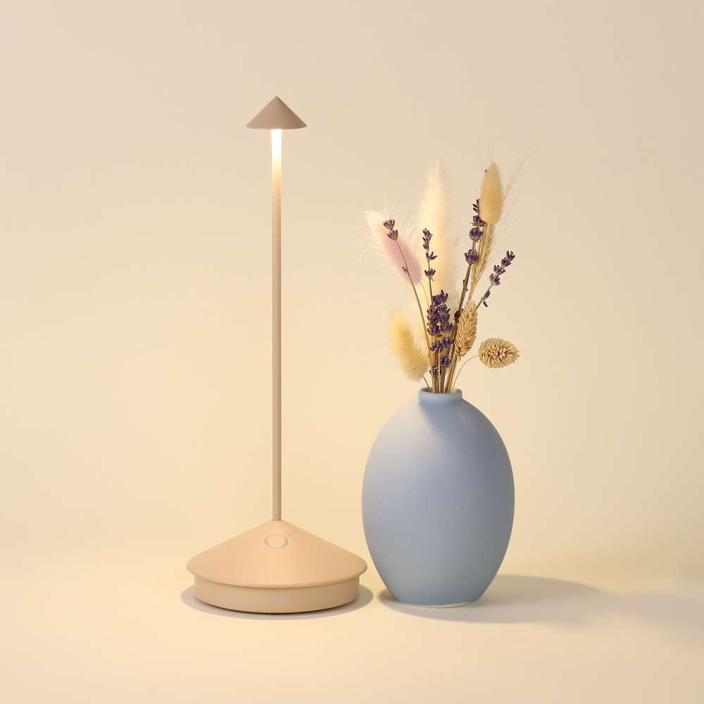 Sand Brown Crate & Barrel Pina Pro Metal Table Lamp by Zafferano America lit and styled on a table surface