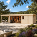 Sauna St. Moritz 70 in the sunny Texas Hill Country with four adults visibly relaxing, stretching, arranging towels, and pouring water over the sauna stones.