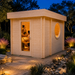 Brightly illuminated Sauna Tuuli 90 with two visible adults enjoying the sauna in a landscaped Texas Hill Country courtyard.