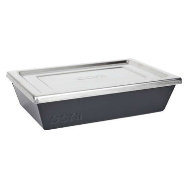 Small Ooni Detroit Pizza Pan angled view with the stainless steel lid resting on the dark gray pan and the ooni logo embossed on the side.