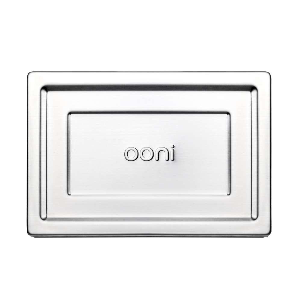 Small Ooni Detroit Pizza Pan overhead view of the brushed stainless steel lid on its own with the ooni logo embossed in the recessed center panel.