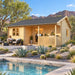 The Sunbeam Lakehouse 70mm configured as a sunny Nevada home office, with adults working inside and relaxing beside its long covered timber porch.
